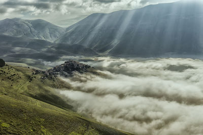 Scenic view of cloudscape against mountains