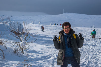 Rearview of a man skiing on a snow-covered landscape.