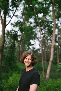 Portrait of smiling young man in forest