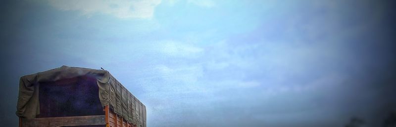 Low angle view of building against cloudy sky