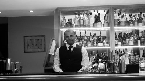 Portrait of smiling bartender in bar