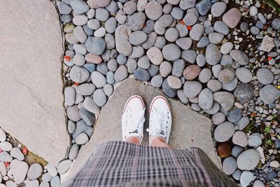 Low section of woman standing on rock