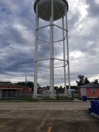 Low angle view of street by building against sky