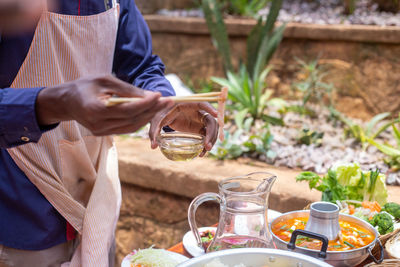 Midsection of man preparing food