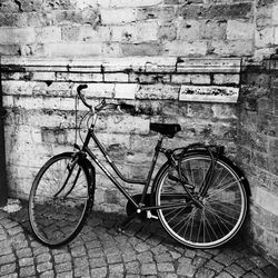 Bicycle parked against wall