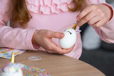 Midsection of woman holding egg