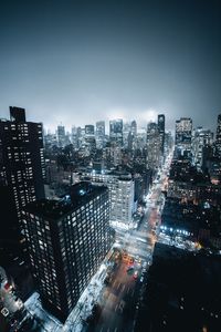 Illuminated cityscape against clear sky