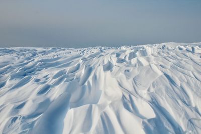 Scenic view of snowcapped mountains against clear sky