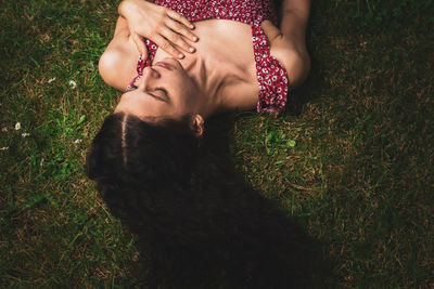 High angle view of woman lying on field