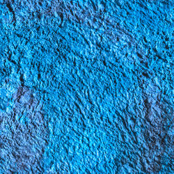 Full frame background and texture of blue decorative plaster on outside wall of the building