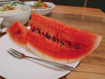 Close-up of watermelon slices in plate on table