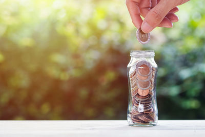 Close-up of hand holding glass jar