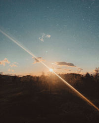 Scenic view of field against sky at sunset