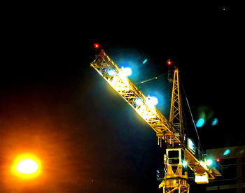 Low angle view of illuminated street light against sky at night