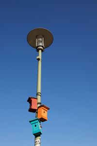 Low angle view of street light against clear blue sky