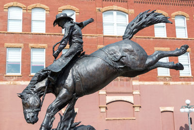 Statue against buildings in city