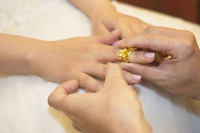 Midsection of couple holding hands