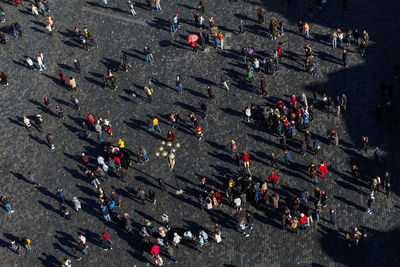 High angle view of people and long shadows on street