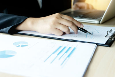 Midsection of business person working on table