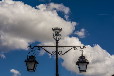 Low angle view of street light against blue sky