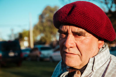 Portrait of man wearing red hat in city