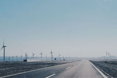 Empty road along countryside landscape