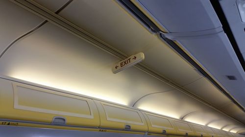 Low angle view of illuminated text on ceiling