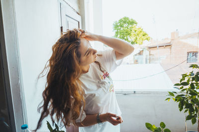 Woman standing by window