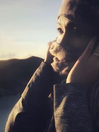 Close-up of young man against sky