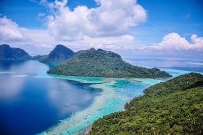 Panoramic view of sea and mountains against sky