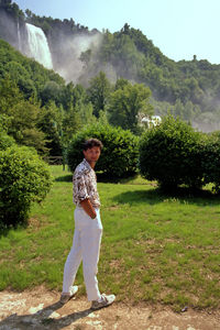 Full length of man standing on land against trees