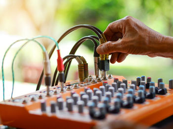 Close-up of human hand adjusting sound mixer