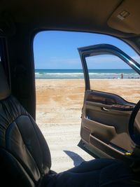 Scenic view of sea seen through car windshield