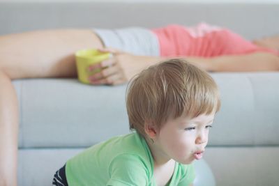 Portrait of boy sitting on sofa at home