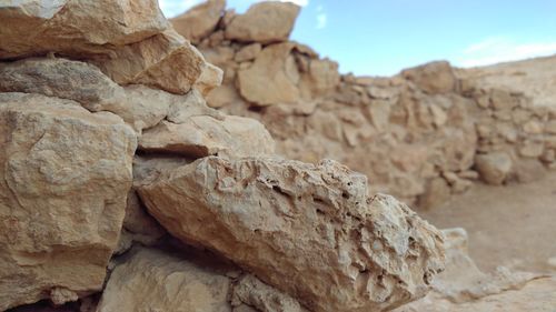 Close-up of rock formation against sky