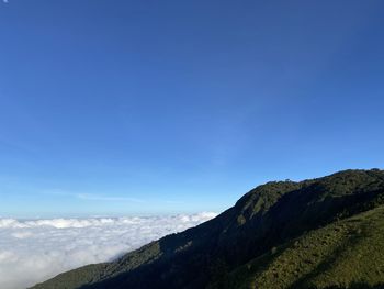 Scenic view of mountains against blue sky