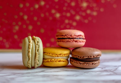 Sweet holiday macaron still life against a red background