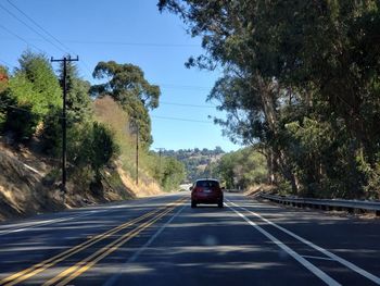 Cars on road against sky