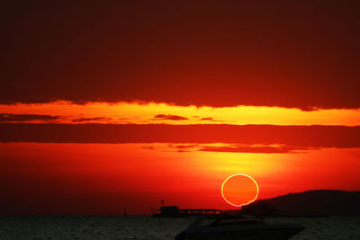 Scenic view of sea against romantic sky at sunset