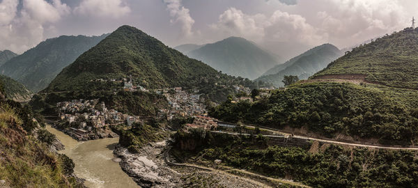 Panoramic view of trees and mountains against sky