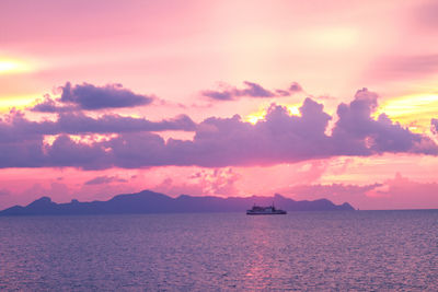 Scenic view of sea against dramatic sky during sunset