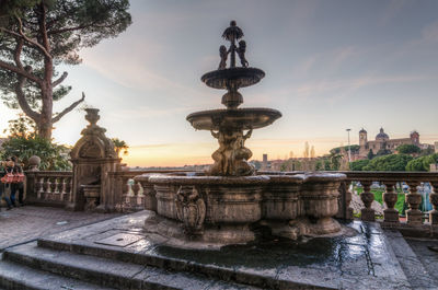 Statue of fountain at sunset