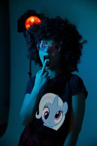 Portrait of young woman holding camera