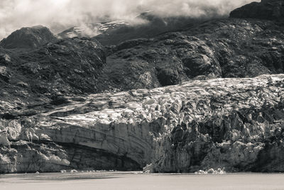 Scenic view of sea by mountains