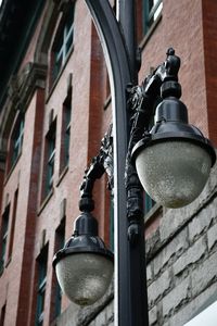 Low angle view of street light against building