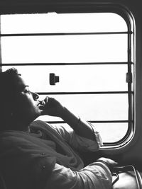 Side view portrait of man sitting in bus