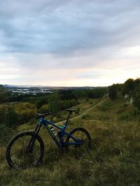 Bicycles on field against sky