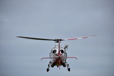 Low angle view of helicopter against sky