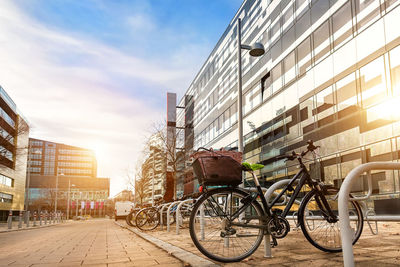 Bicycles on street against buildings in city