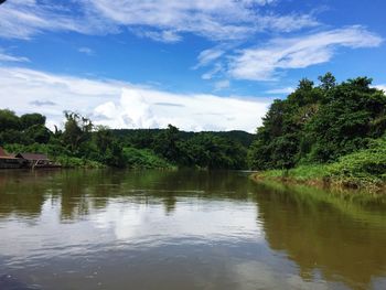 Scenic view of river in forest against sky